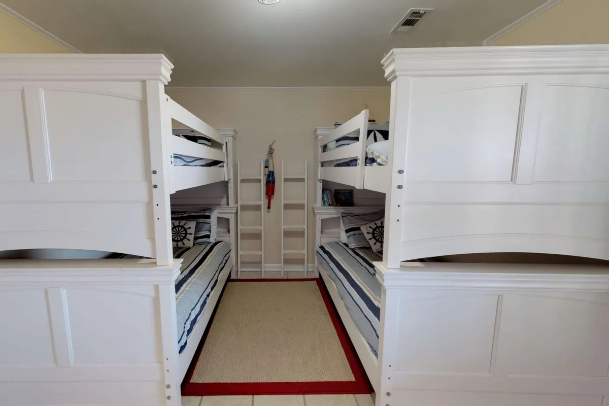 A playful, cozy bunk room with colorful bedding, a sturdy ladder, and whimsical decorative pillows. The arrangement invites sleepovers, reading, and imaginative play, catering to children's comfort and safety.